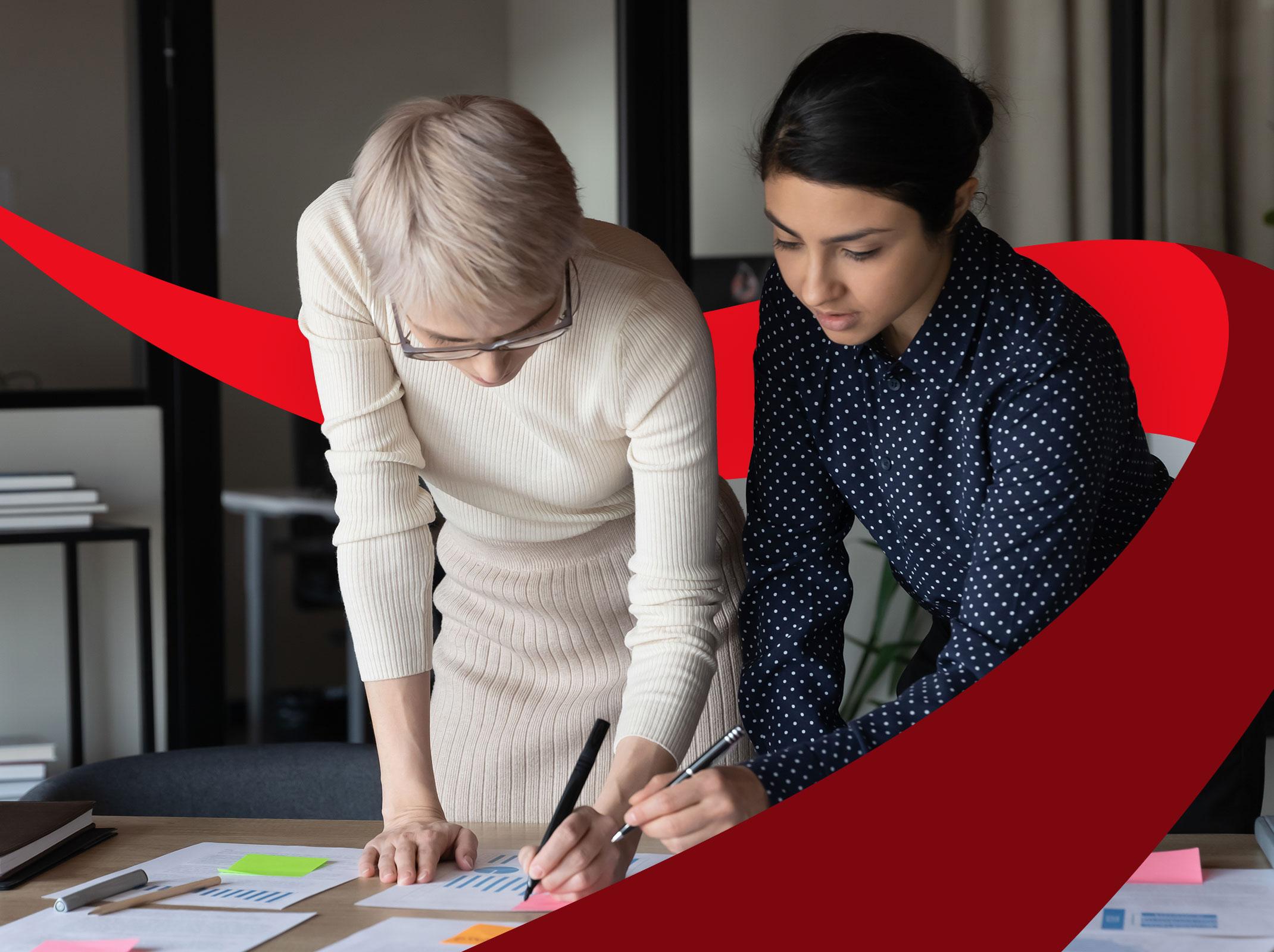 Two professional female coworkers creating new ideas