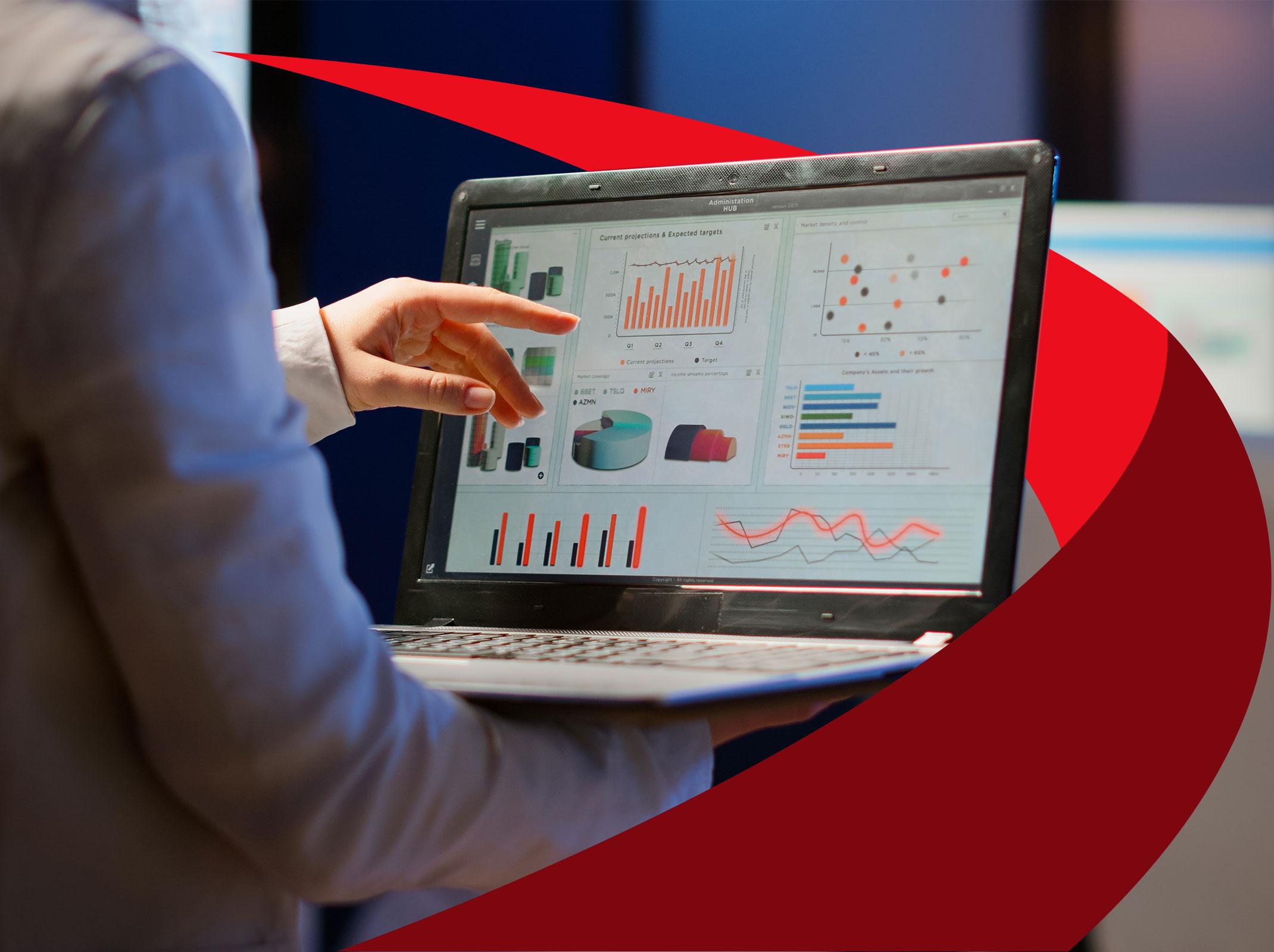 Professional pointing at charts and graphs on a business laptop