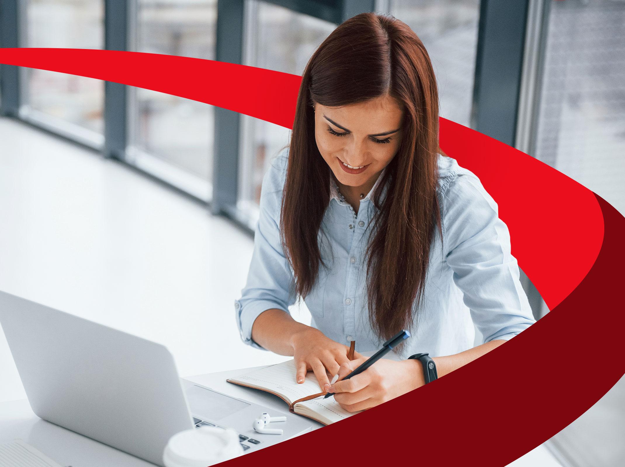 Administrative Professional writing at desk