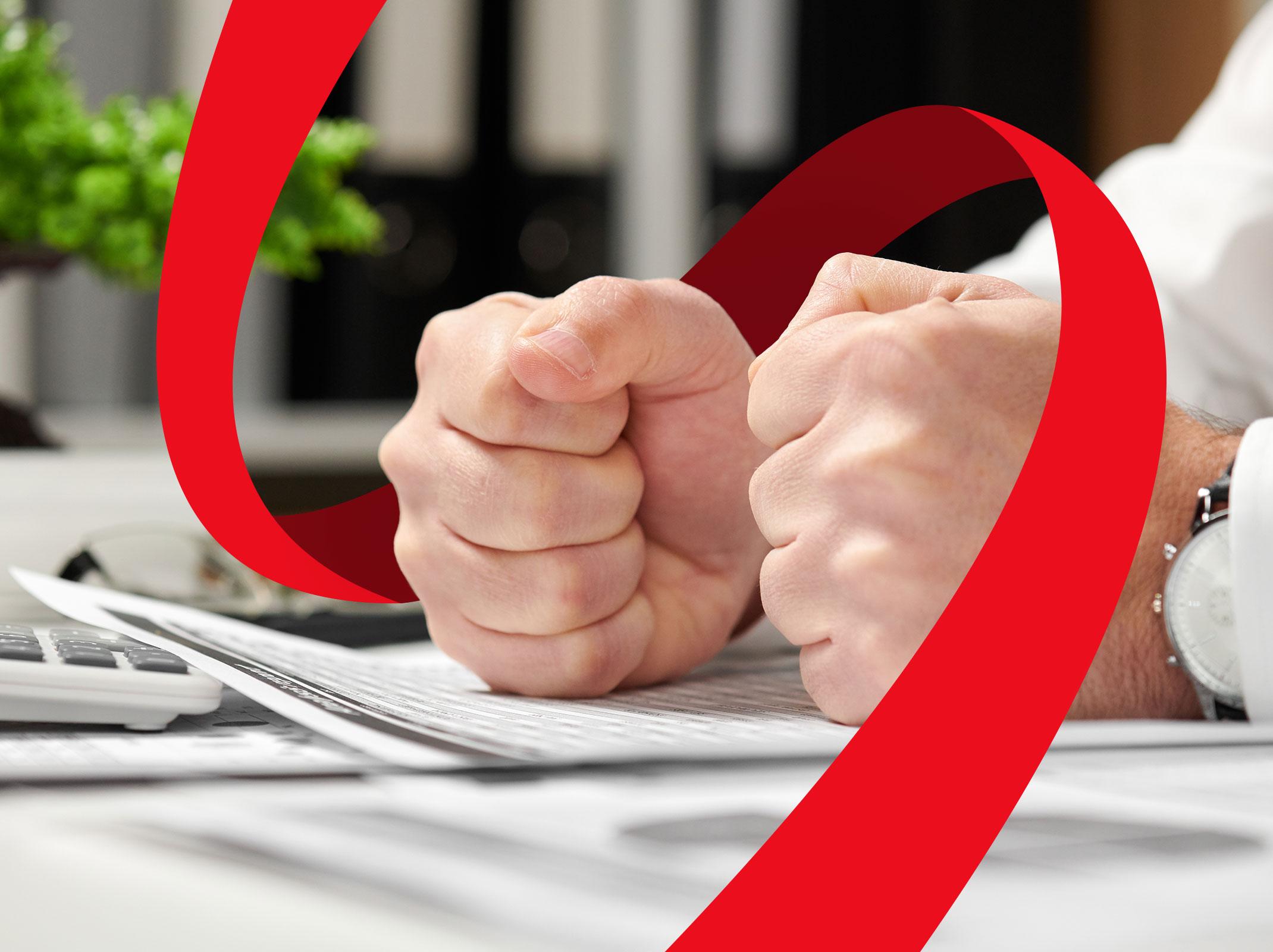Two fists pounding on a desk
