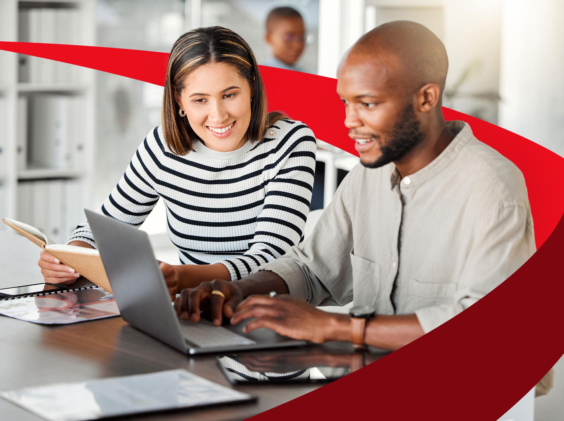 Two business professionals working on content writing on a laptop.