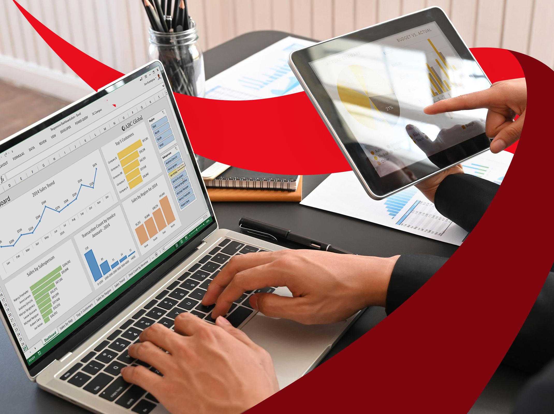 Two business professionals reviewing Microsoft Excel dashboards on laptops and tablets.