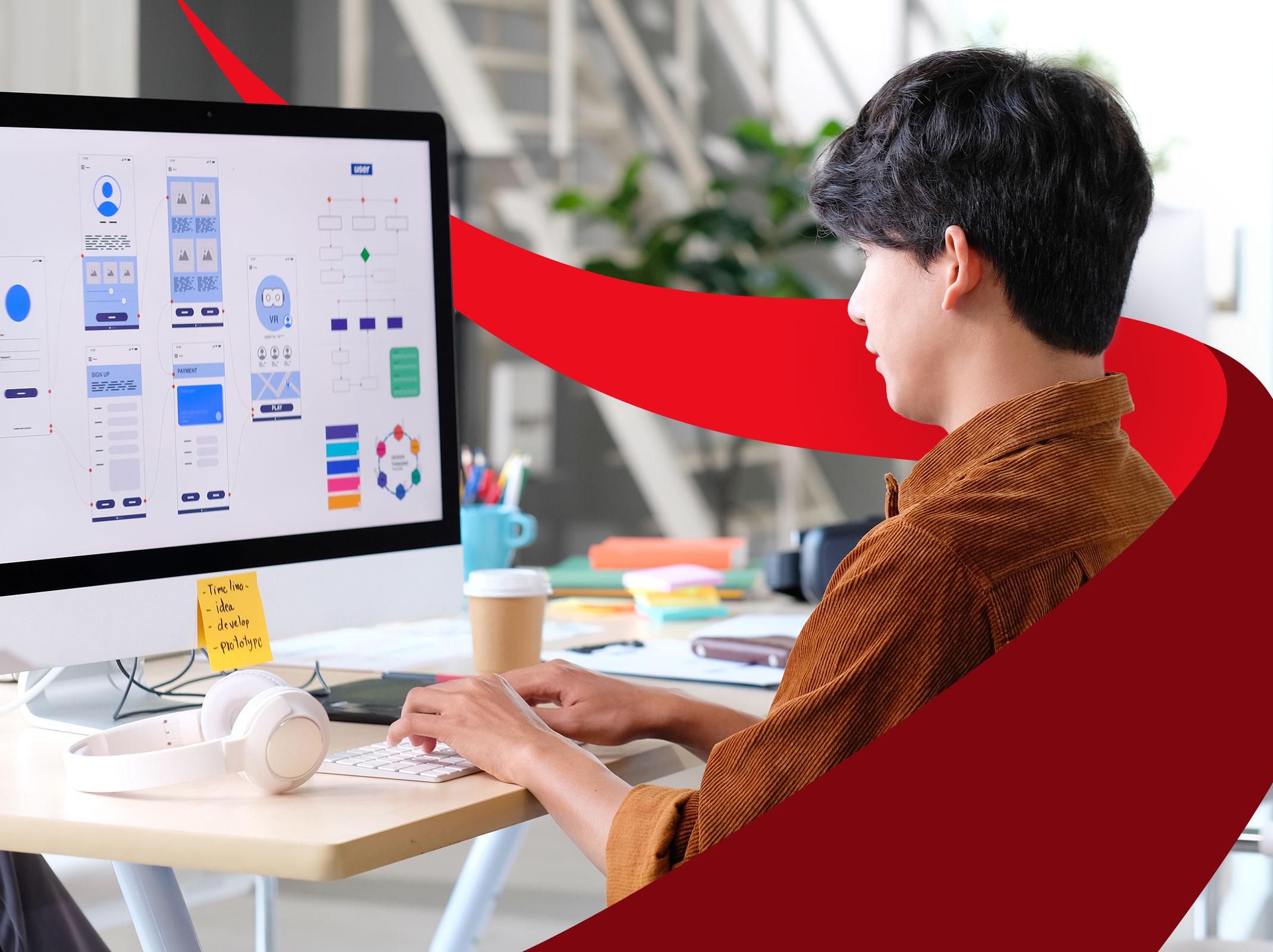 Business professional designing on a large screen in a business setting.