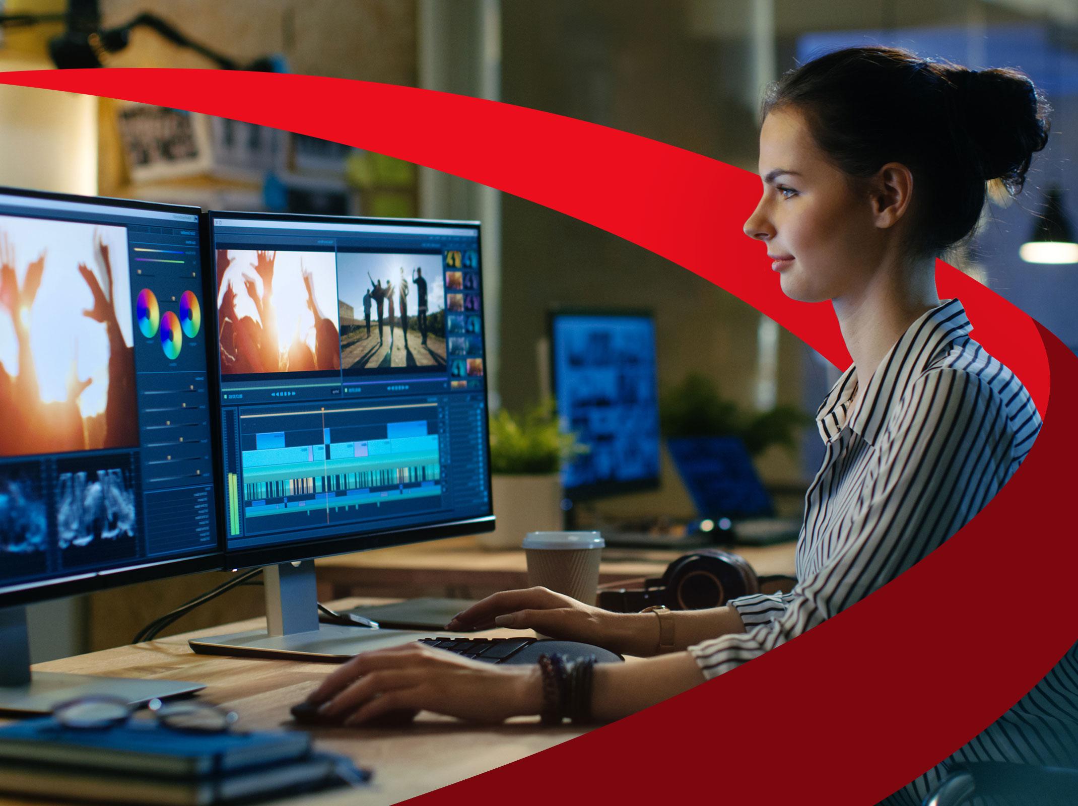 A business professional reviewing information on multiple computer screens related to digital marketing. 