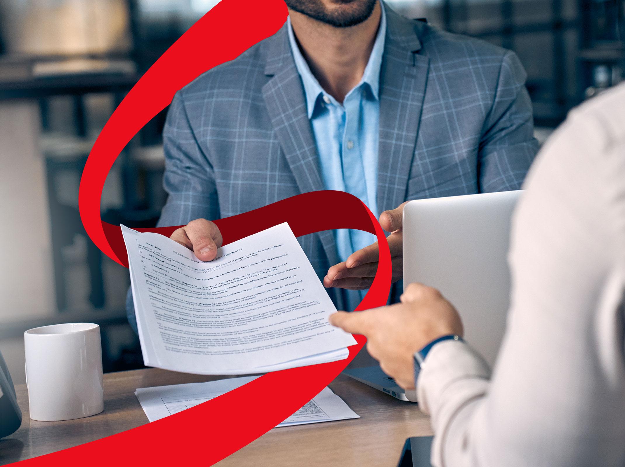 Business professional handing FMLA paperwork to another business professional