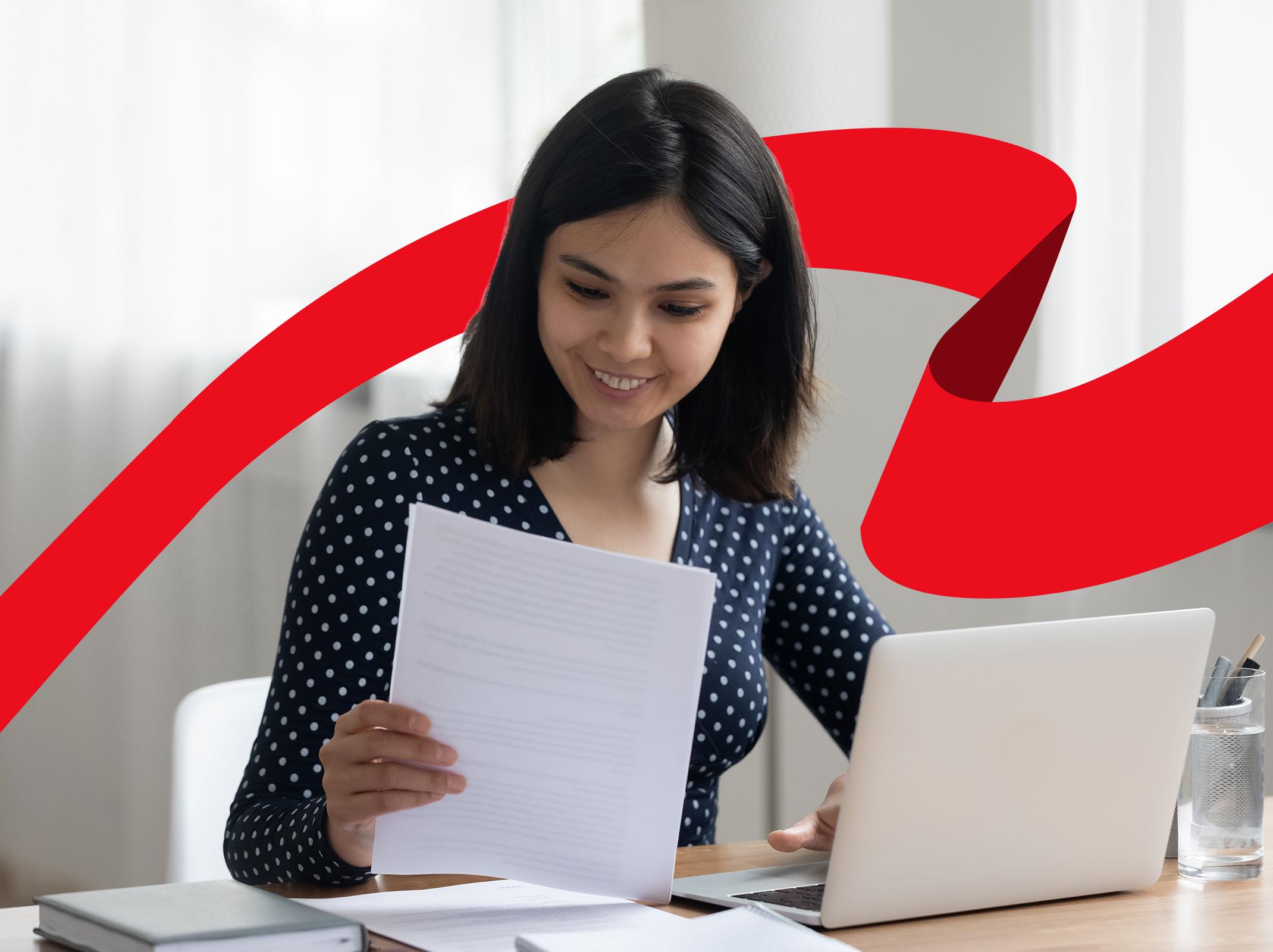 Employee working on writing policies and procedures at a laptop 