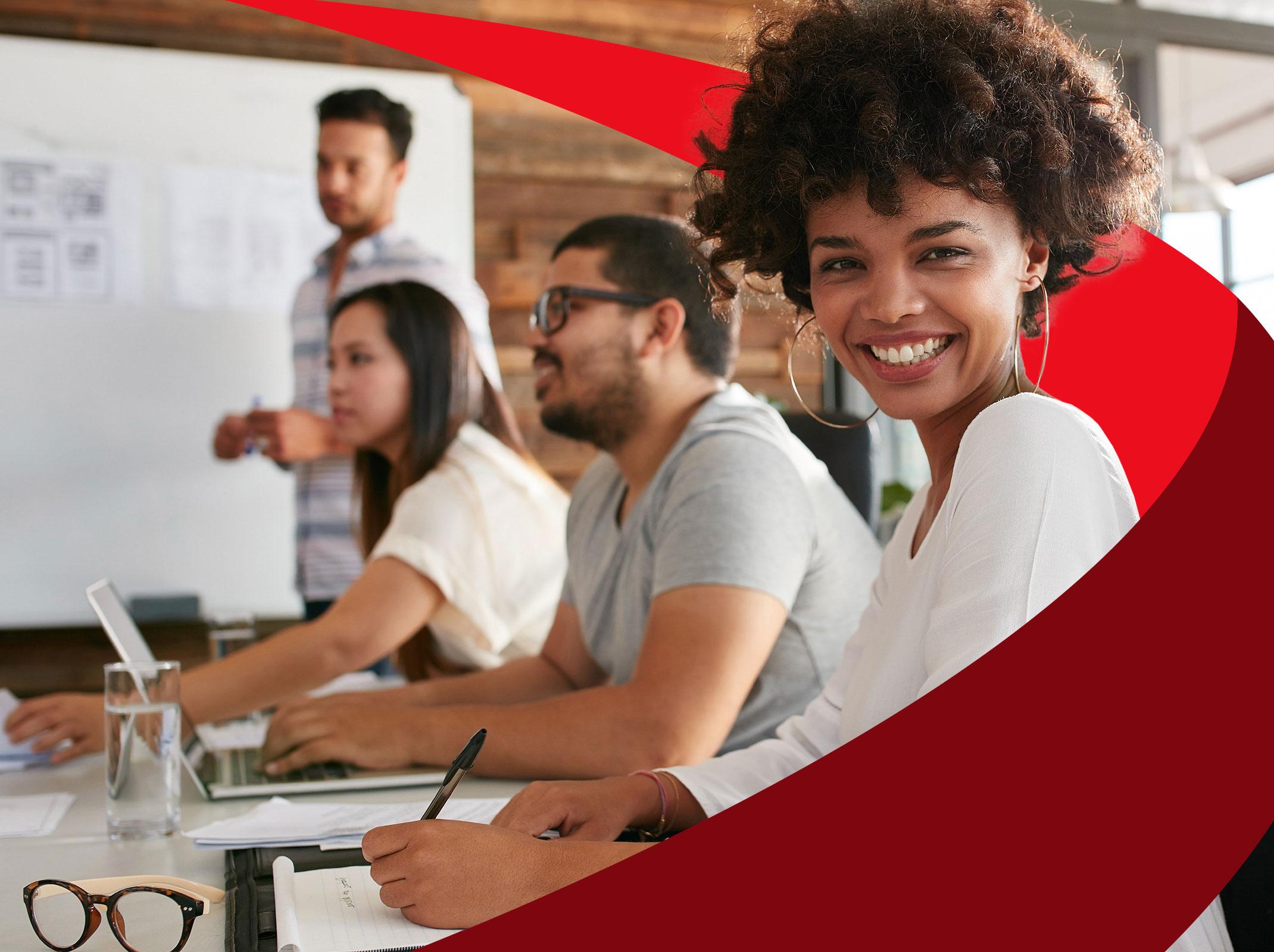 Diverse group of business professionals working together around a conference table.