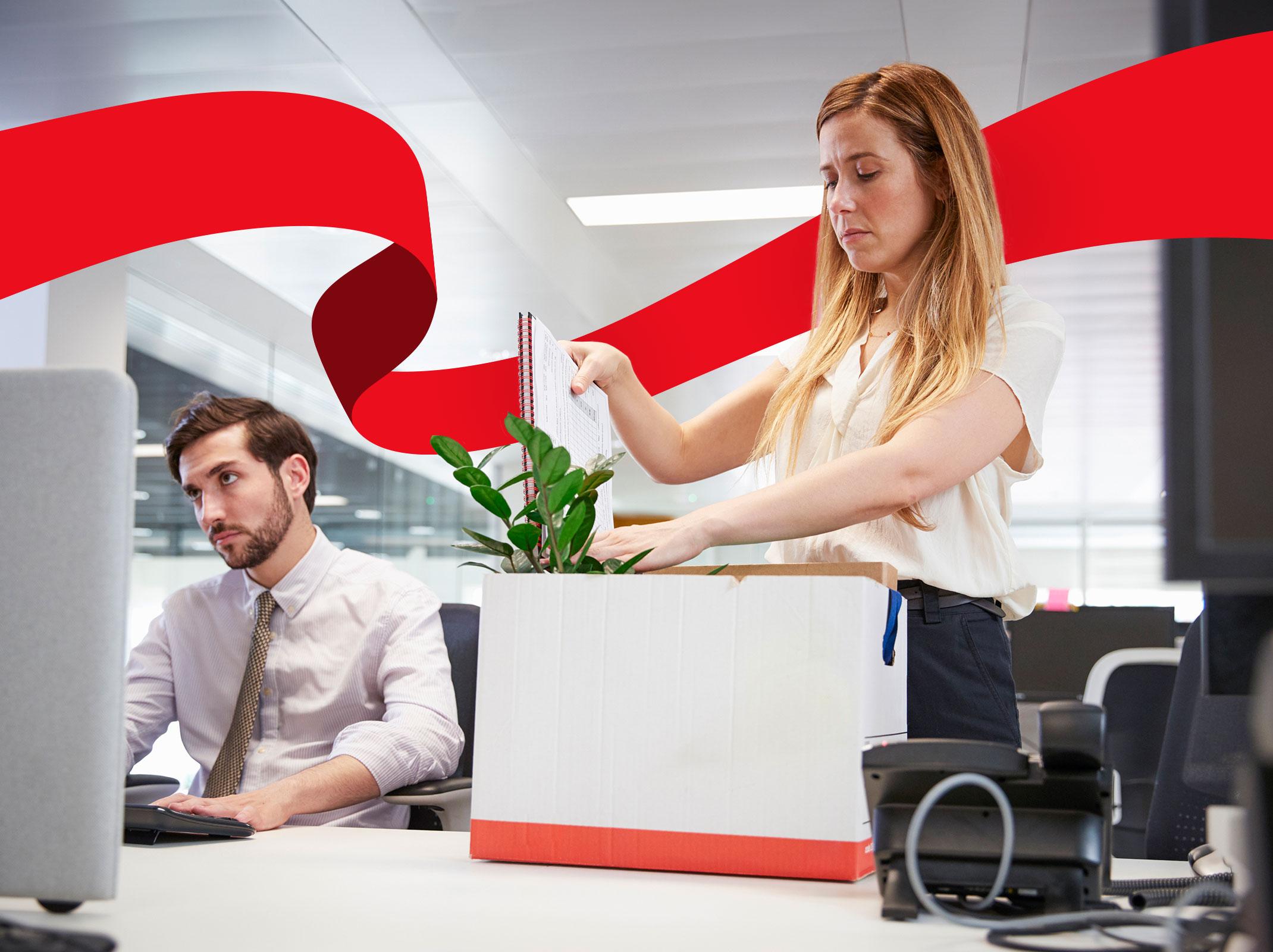 Woman packing up her things into a box at work