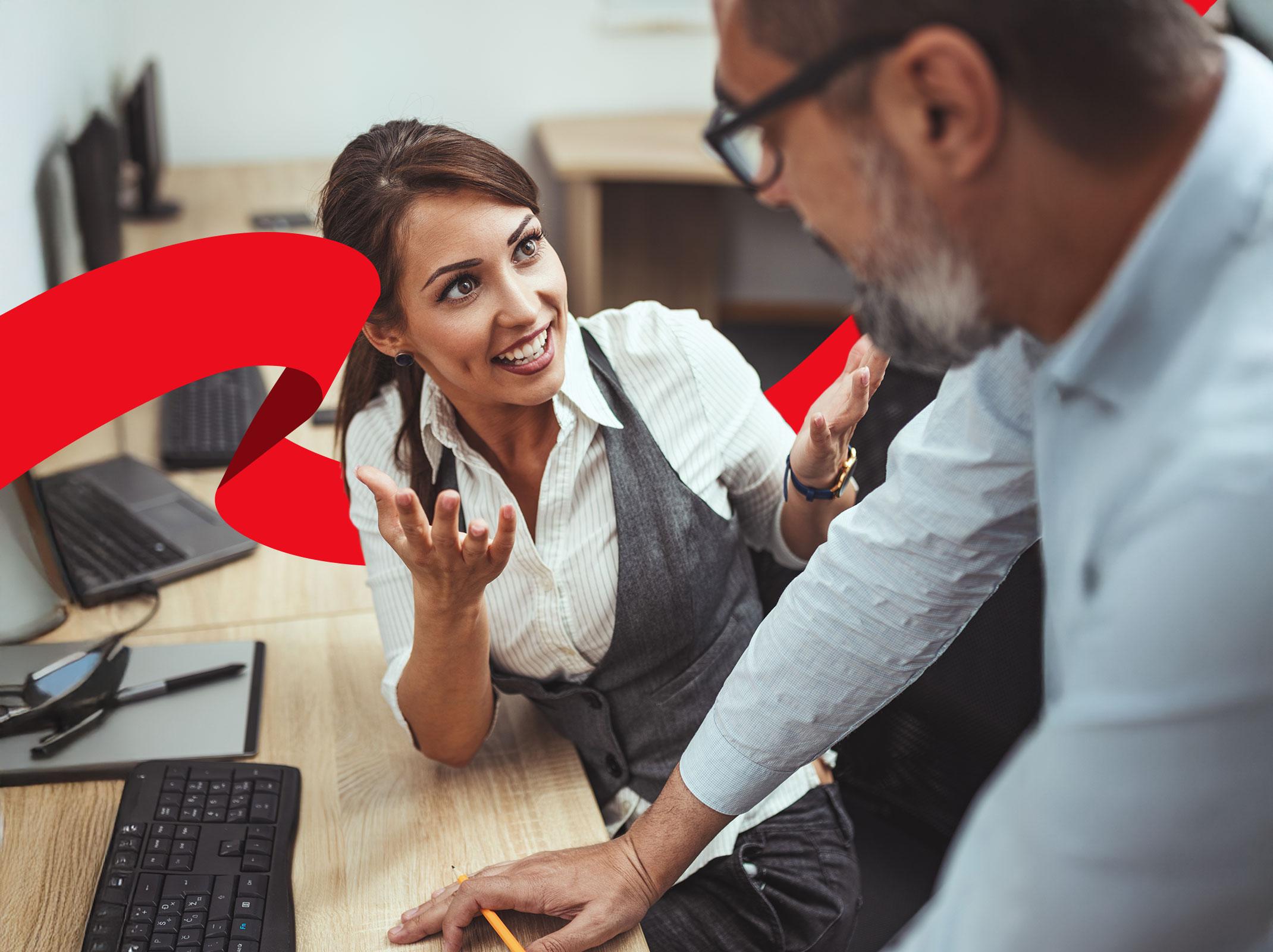 Admin discussing project goals with co-worker in her office space