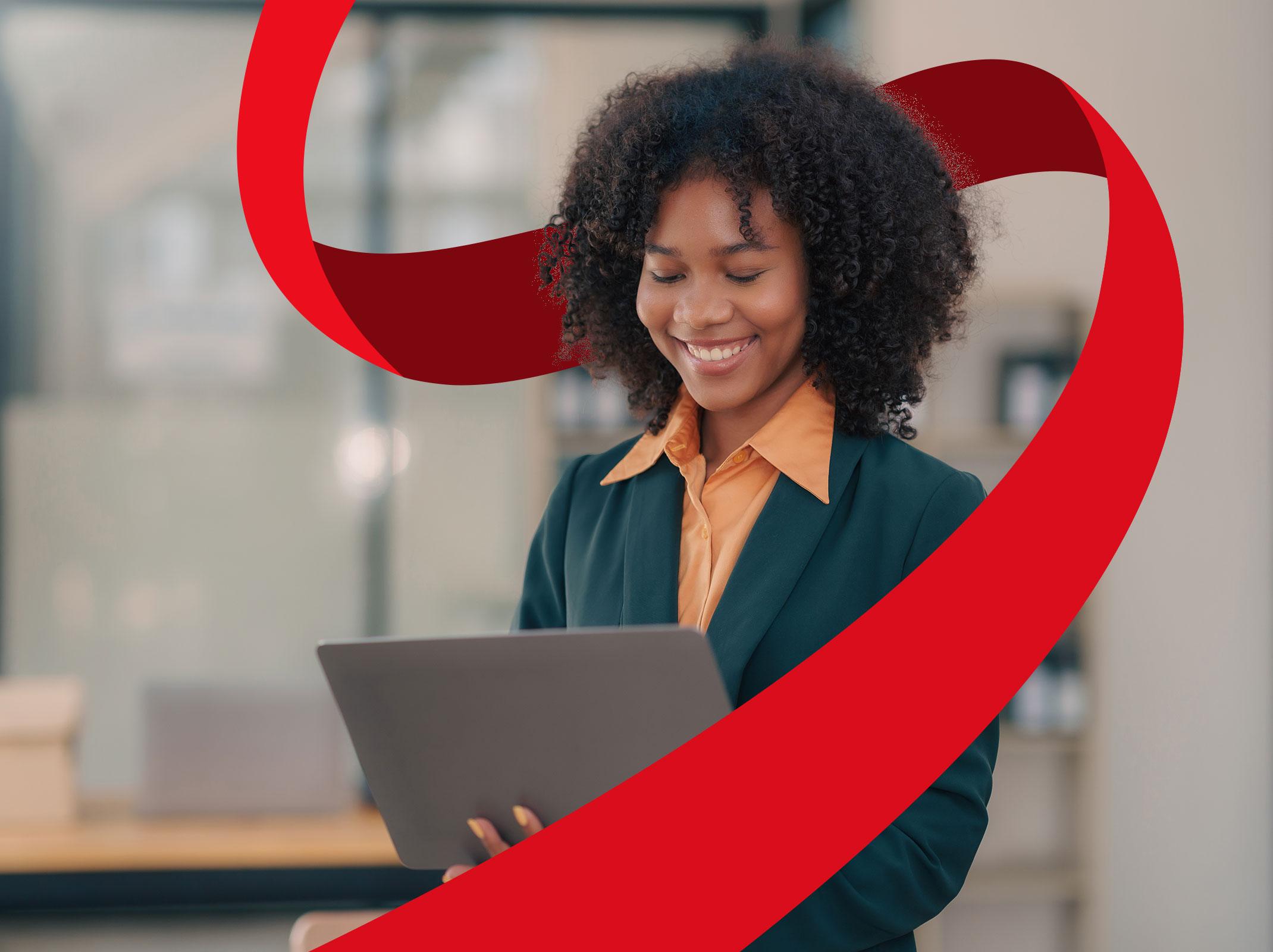 Smiling professional using a laptop—featured in “Mastering Microsoft Copilot for Workplace Productivity” course.