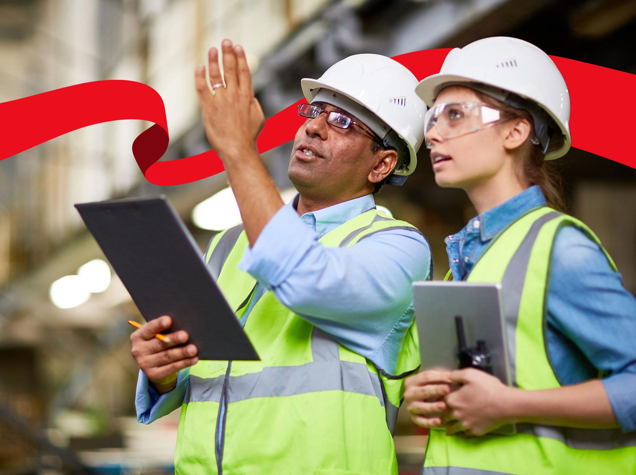 Two construction professionals reviewing  a job site with tablets