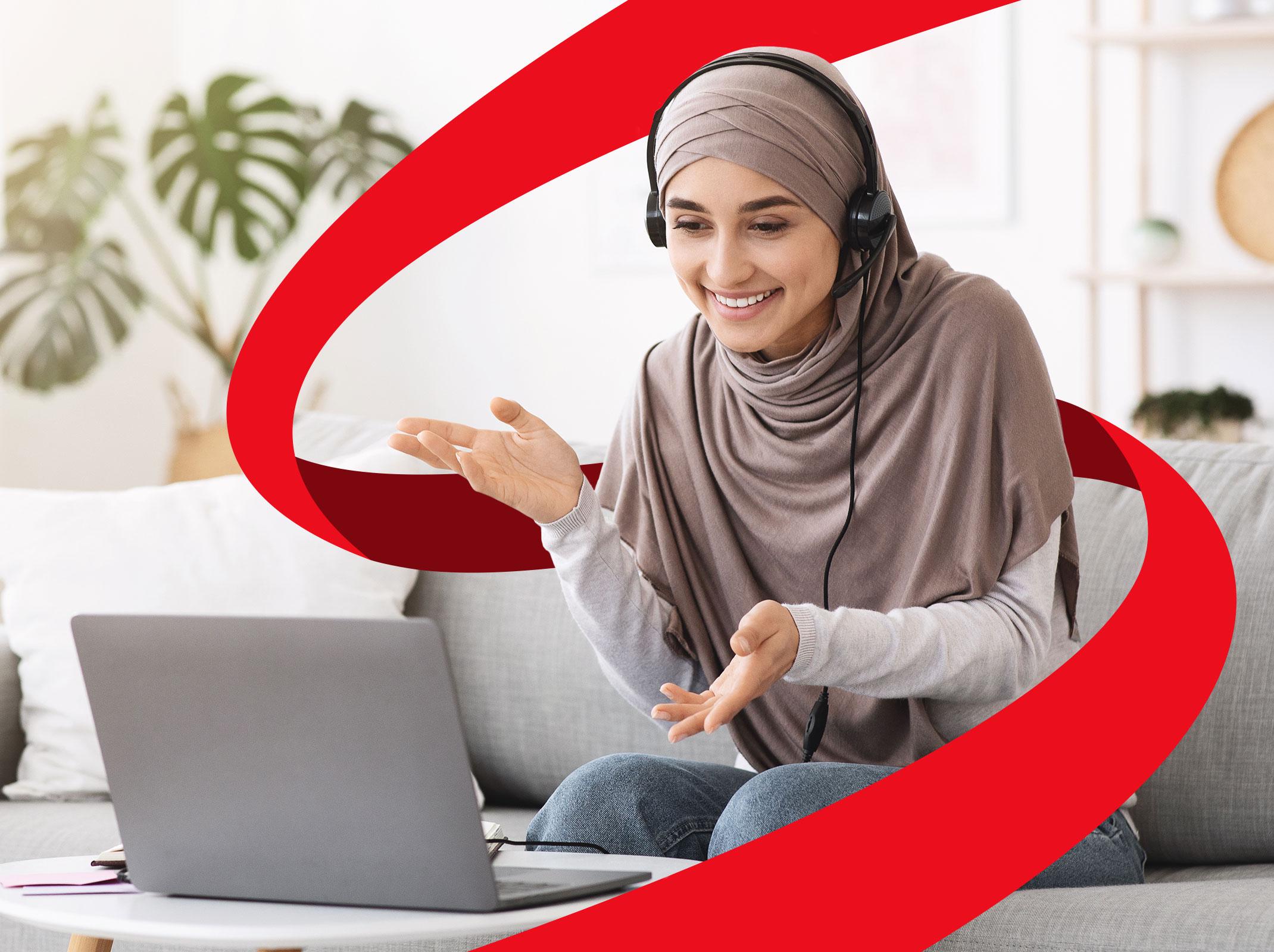 Business professional presenting to a virtual audience with a headset and a laptop.