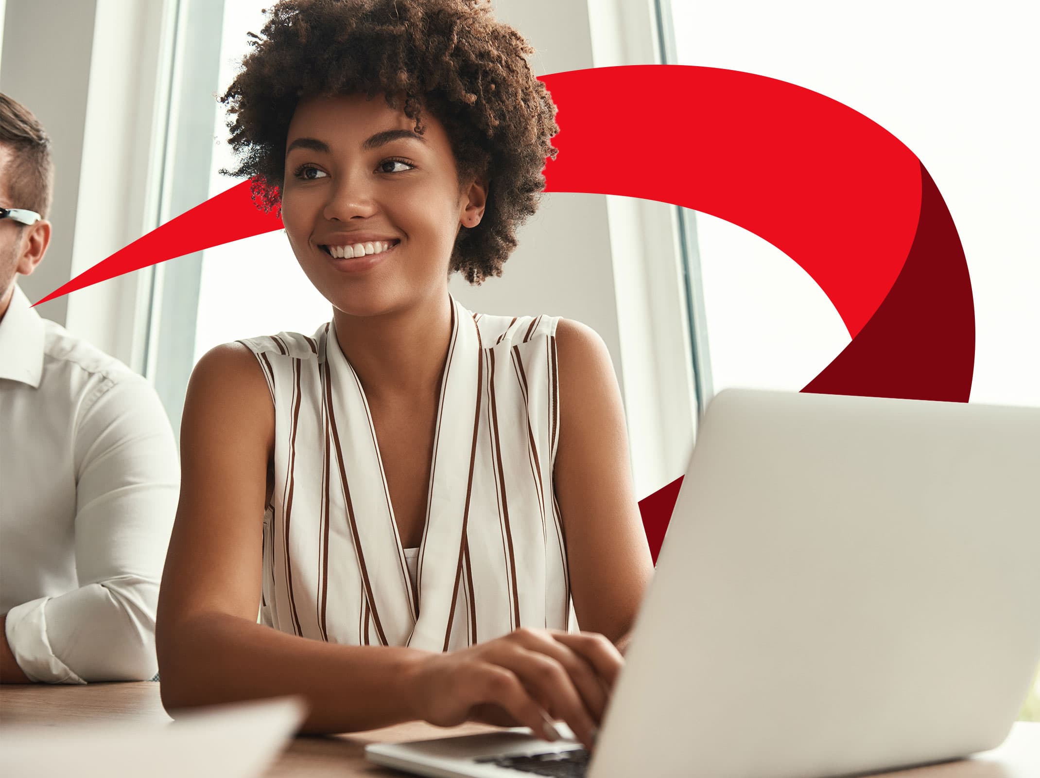 Administrative professional smiling as she works on a laptop